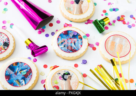 New Year cookies and confetti on white background Stock Photo
