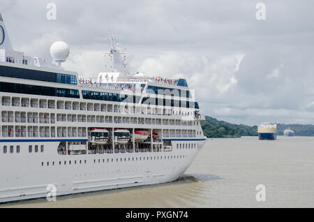 Cruise ship transiting through the Panama Canal at the southwestern end of Gatun Lake.  A roll on - roll out ship can be seen in the distance Stock Photo