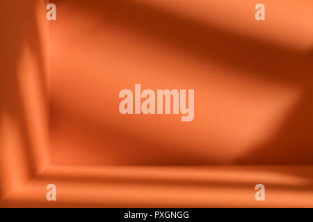 Empty corner of orange room with deep artistic shadow. Minimalistic space concept Stock Photo