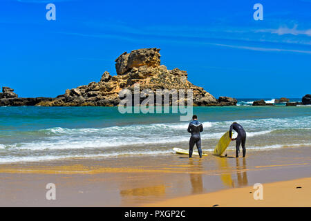 Surfer at the Praia do Castelejo beach at the Costa Vicentina coast, Vila do Bispo, Portugal