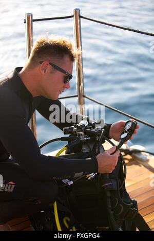 Scuba diver checking equipment Stock Photo