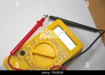 Close-up from above of a digital multimeter with its black and red test tips Stock Photo