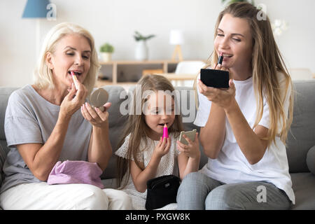 Mother, daughter and granny put make up spending time together Stock Photo