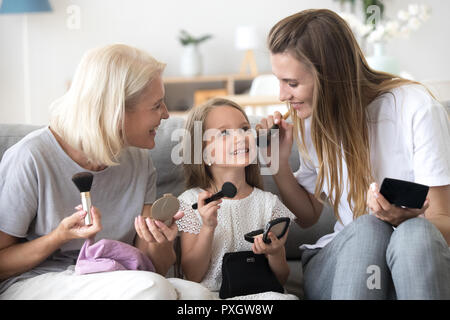 Three generations of women have fun at home together Stock Photo