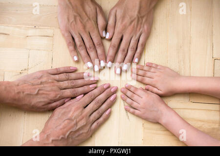 Top view of three generations of women put hands together Stock Photo