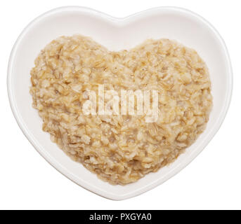 Oatmeal in heart shaped plate isolated on white background Stock Photo
