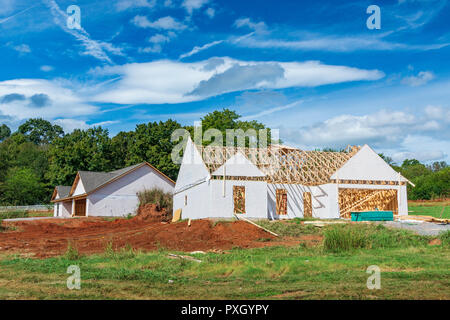 Horizontal shot of two single story new home starts under construction.  Cloudy sky. Stock Photo