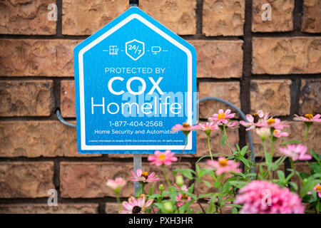 A security system sign posted in front of a home in Wichita, Kansas, USA. Stock Photo