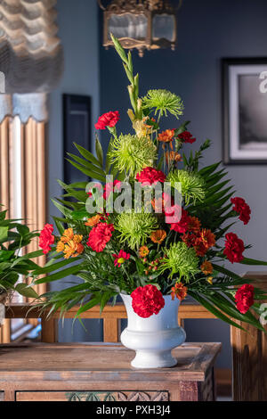 A bouquet of flowers in a white vase. Chrysanthemums and carnations. Stock Photo