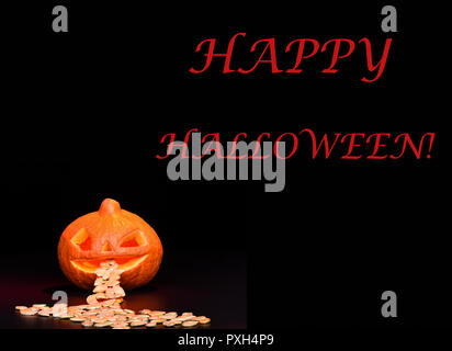 Happy Halloween. Pumpkin with seeds on a black background. Board design. Copy space. Stock Photo
