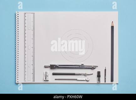 Drawing instruments on the worktable. The devices for the drawing are on the album. Stock Photo