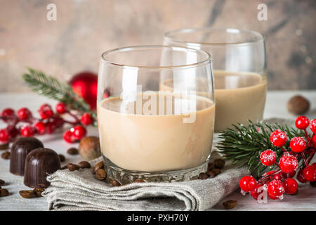 Irish creme liqueur in glass with christmas decorations. Stock Photo