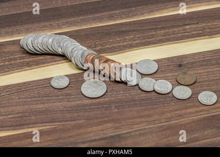 US Coins spread out on solid walnut backdrop.