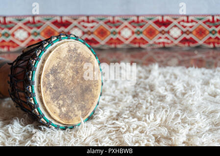 Traditional drum on white carpet Stock Photo