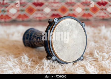 Traditional drum on white carpet Stock Photo