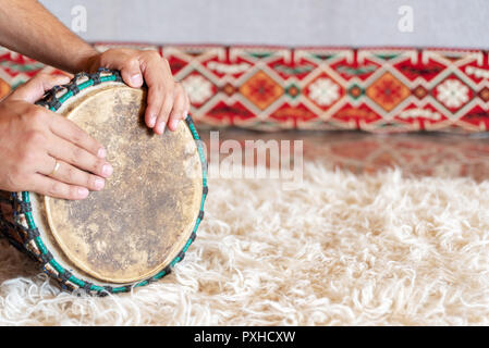 Traditional drum on white carpet Stock Photo