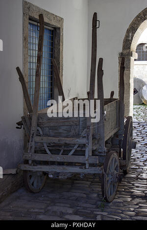 An old carriage that binds to a horse. The plow and blade are loaded on the carriage. Stock Photo
