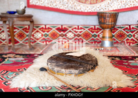 Traditional drum on white carpet Stock Photo