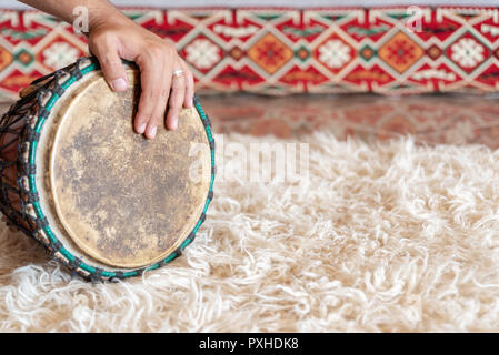 Traditional drum on white carpet Stock Photo
