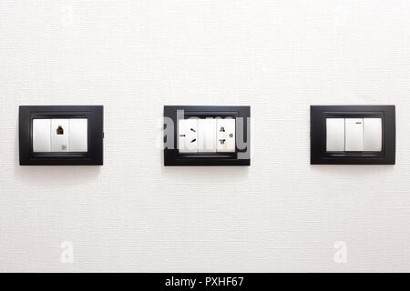Electrical outlets on a white wall Stock Photo