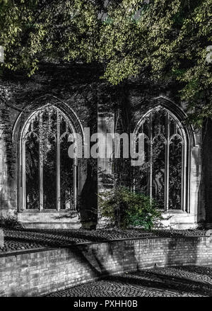 Night image of windows of the disused church, St Dunstan in the East, surrounded by foliage on St Dunstan's Hill, London, England Stock Photo