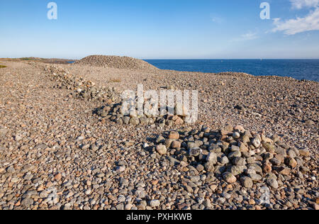 Iron Age cairns made of cobble deposits from the recent ice age on Molen beach of rolling stones at UNESCO Global Geopark near Larvik, Vestfold County Stock Photo