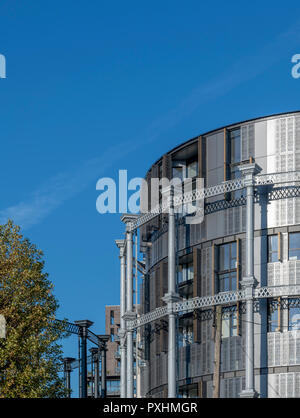 Iconic grade II listed gas holders re-used for housing at King's Cross in London. One of the towers has been converted into Gasholder Park. Stock Photo