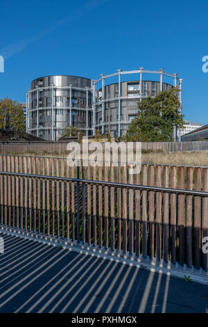 Iconic grade II listed gas holders re-used for housing at King's Cross in London. One of the towers has been converted into Gasholder Park. Stock Photo