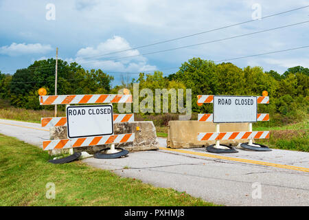 Horizontal shot of two beaten up road closed signs. Stock Photo