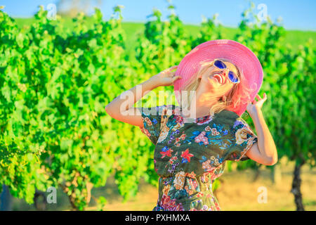 Vineyard winery grape picking. Harvest farming to make white wine. Caucasian woman with big hat enjoys at Wilyabrup in Margaret River or wine region in Western Australia. Popular wine tasting tours. Stock Photo