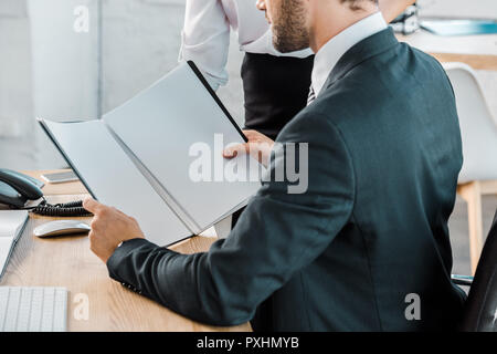 cropped image of businessman reading documents in office Stock Photo