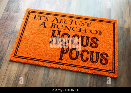 It's All A Bunch Of Hocus Pocus Halloween Orange Welcome Mat On Wood Floor Background. Stock Photo