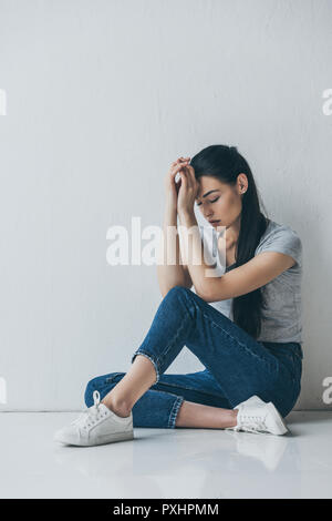 Woman in Ripped Jeans Posing in Studio · Free Stock Photo