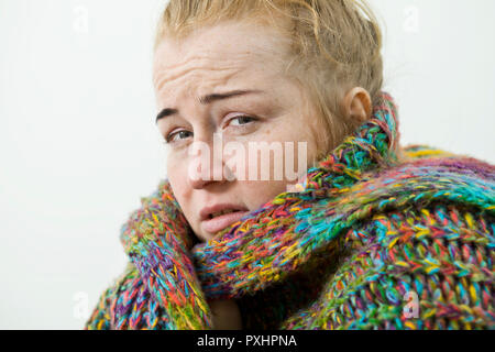 Young woman suffering from cold and flu at home, closeup