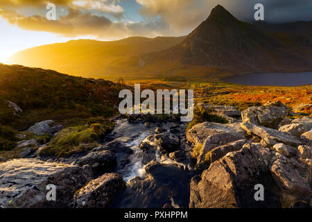 Spectacular sunrise over the majestic Ogwen Valley and recognisasble mountain Tryfan in Snowdonia National Park, Conwy, Wales popular fir walking Stock Photo