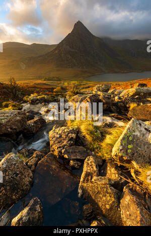 Spectacular sunrise over the majestic Ogwen Valley and recognisasble mountain Tryfan in Snowdonia National Park, Conwy, Wales popular fir walking Stock Photo