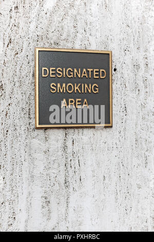 Designated Smoking Area black and gold sign on the side of a building in Cleveland, Ohio, USA. Stock Photo