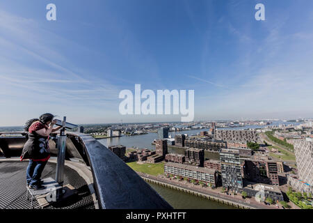 image of a woman observing through a telescope the city of Rotterdam in the Netherlands Holland Stock Photo