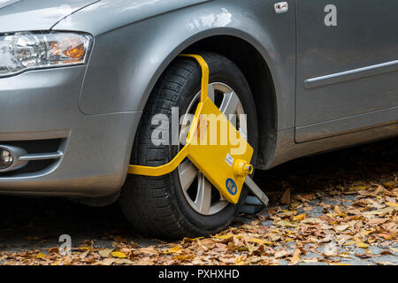 Yellow wheel clamp on parked car in Plovdiv, Bulgaria
