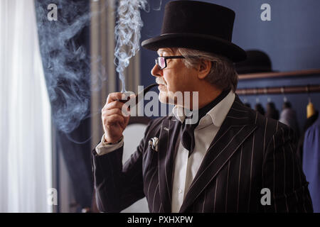 Portrait of posh mature gentleman visiting a tailor's shop Stock Photo