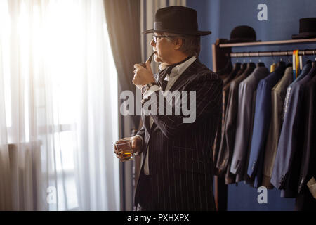 Portrait of posh mature gentleman visiting a tailor's shop Stock Photo