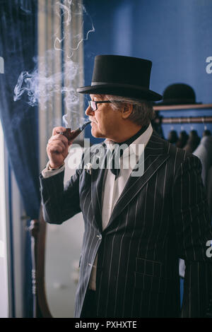 Portrait of posh mature gentleman visiting a tailor's shop Stock Photo