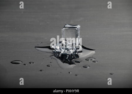 Melting ice on black surface Stock Photo