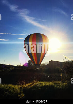 Colorful hot air balloons taking off with sunlight behind, Tuscany in Italy. Stock Photo