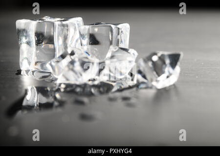 Melting ice on black surface Stock Photo - Alamy