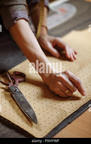 Woman tailor draw dress pattern of product on paper and participate in ...