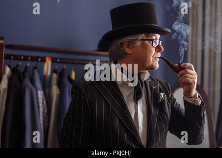 Portrait of posh mature gentleman visiting a tailor's shop Stock Photo