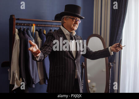 Portrait of posh mature gentleman visiting a tailor's shop Stock Photo