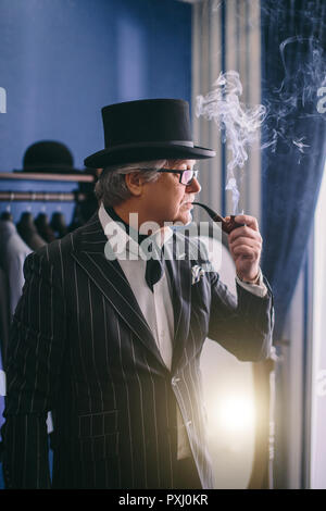 Portrait of posh mature gentleman visiting a tailor's shop Stock Photo