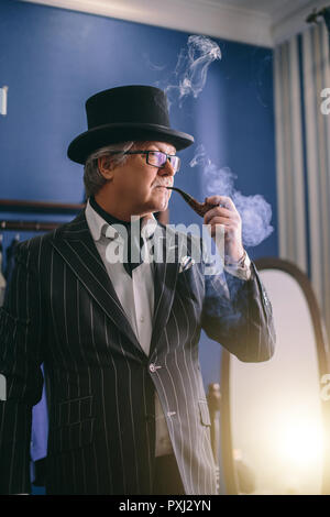 Portrait of posh mature gentleman visiting a tailor's shop Stock Photo